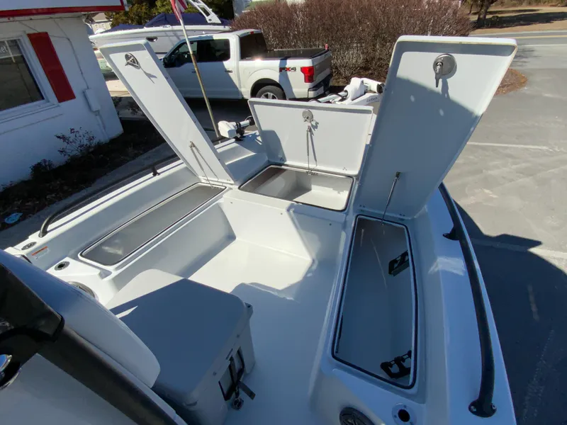 Slide: The Image of 2023 Pathfinder 2200 TRS boat interior with open storage compartments and seating. - 33