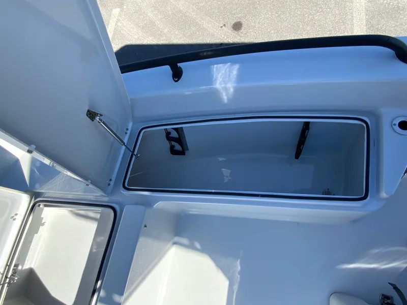 Slide: The Image of 2023 Pathfinder 2200 TRS boat storage compartment, open and empty, with clean interior. - 34