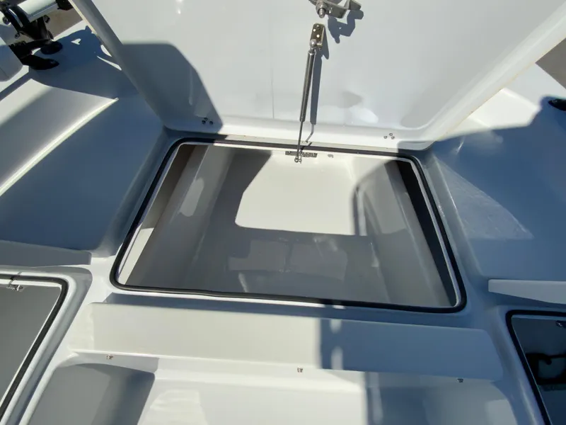 Slide: The Image of 2023 Pathfinder 2200 TRS boat storage compartment with open lid, showcasing interior space. - 35