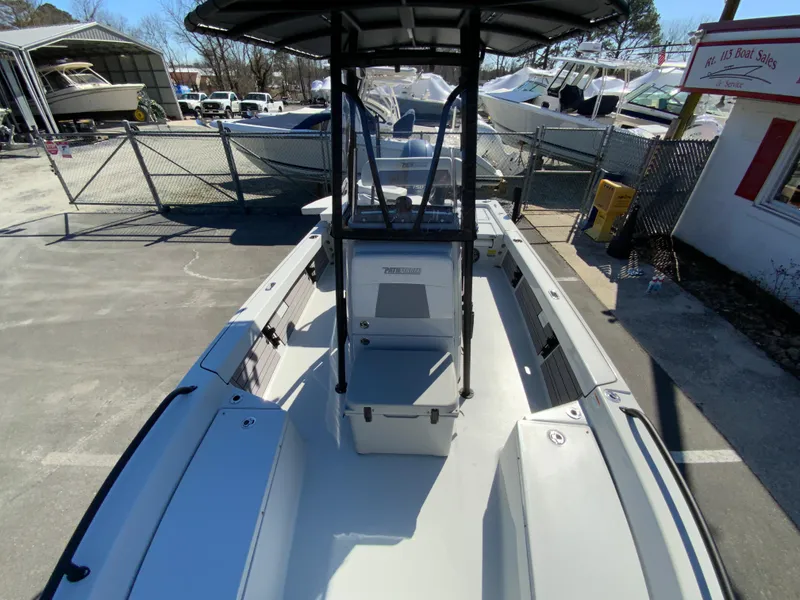 Slide: The Image of 2023 Pathfinder 2200 TRS boat, docked outdoors, showcasing spacious deck and seating. - 37