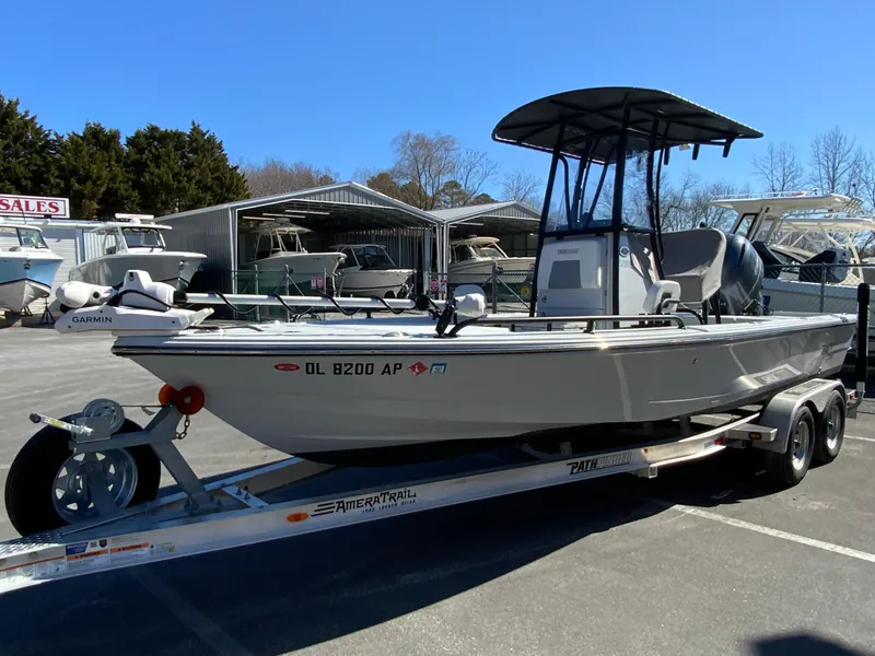 Slide: The Image of 2023 Pathfinder 2200 TRS boat on trailer, parked outdoors at a dealership. - 4