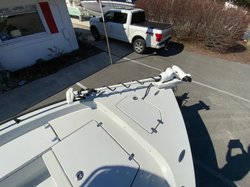 Slide: The Image of 2023 Pathfinder 2200 TRS boat with trolling motor, parked near a white pickup truck. - 41