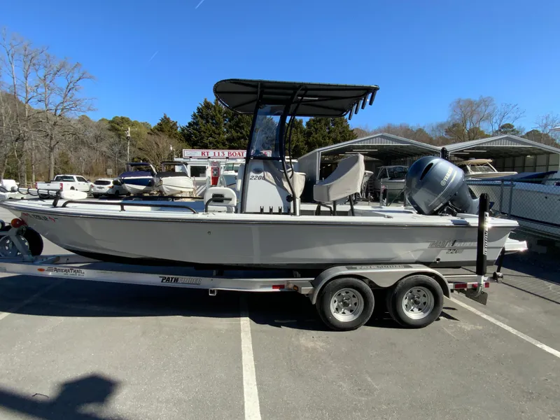 Slide: The Image of 2023 Pathfinder 2200 TRS boat on trailer in parking lot, clear blue sky. - 5