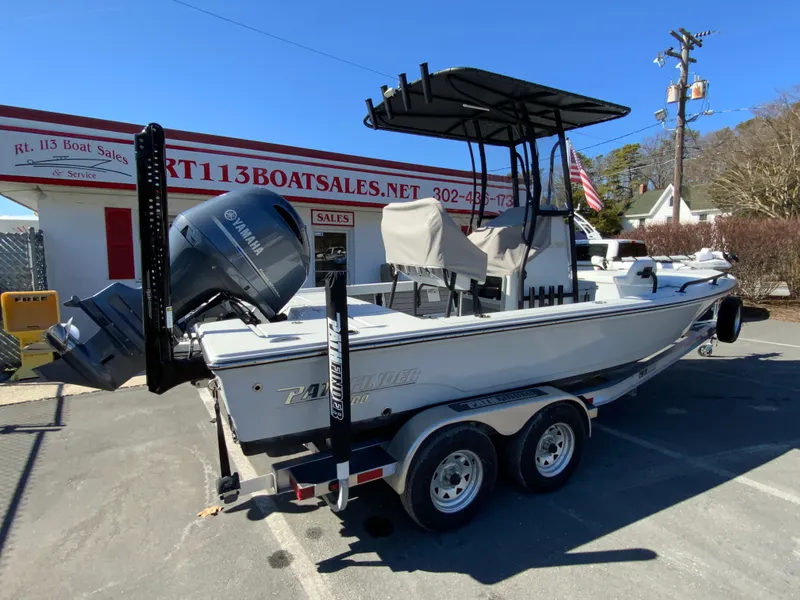 Slide: The Image of 2023 Pathfinder 2200 TRS boat on trailer at dealership, featuring Yamaha outboard motor. - 9
