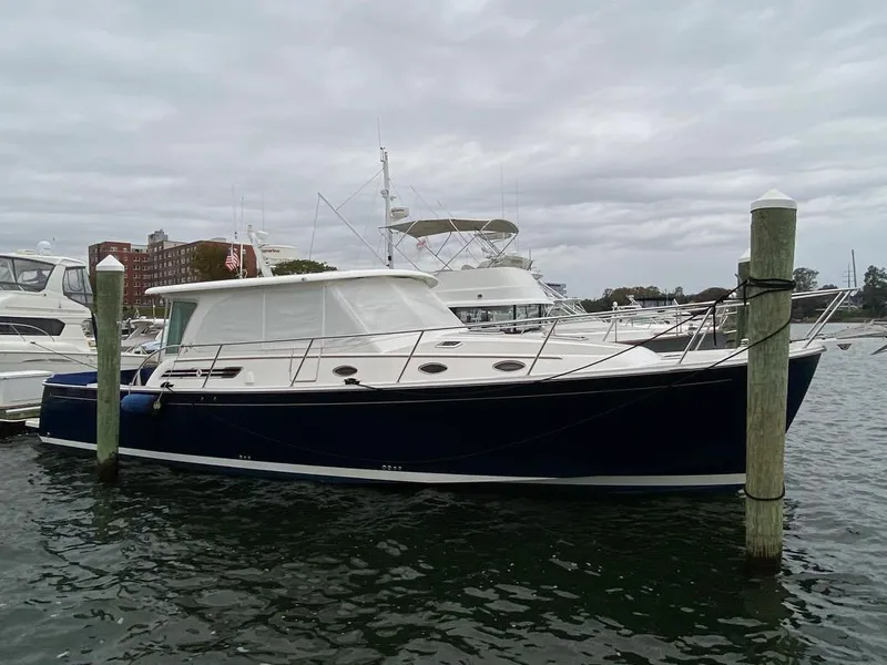 The Image of 2014 Back Cove 41 yacht docked in a marina under cloudy skies. - 0