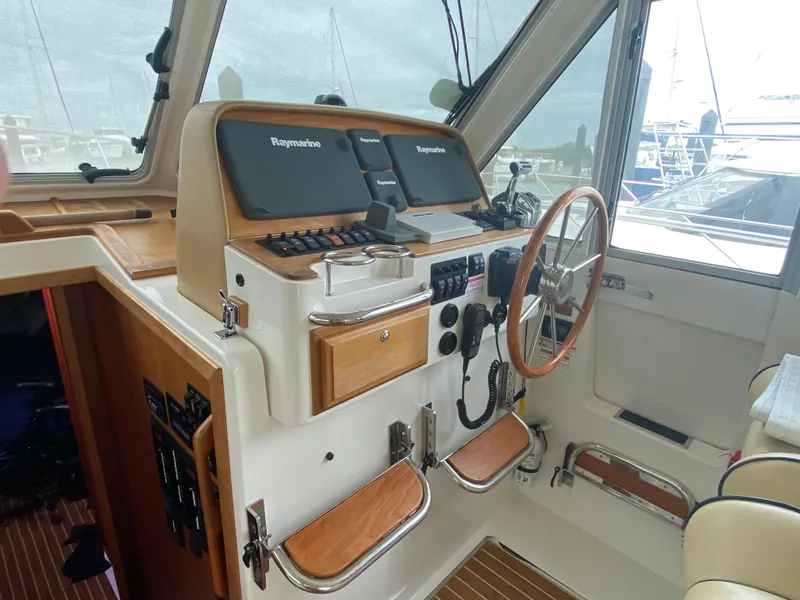 Slide: The Image of Interior helm of 2014 Back Cove 41 boat with navigation equipment and wooden accents. - 22