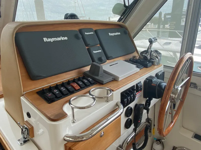 Slide: The Image of 2014 Back Cove 41 helm with Raymarine electronics and wooden steering wheel. - 25