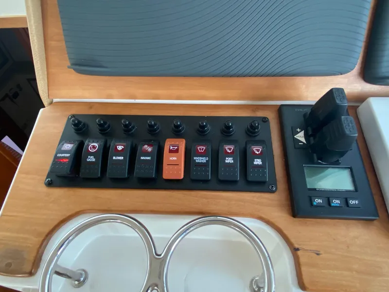 Slide: The Image of Control panel of a 2014 Back Cove 41 boat with switches and display. - 28