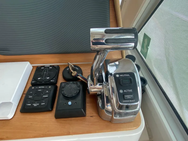 Slide: The Image of Control panel of a 2014 Back Cove 41 boat, featuring throttle and switches. - 29