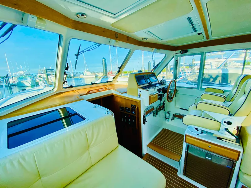 Slide: The Image of Interior of 2014 Back Cove 41 yacht with luxurious seating and navigation controls. - 30