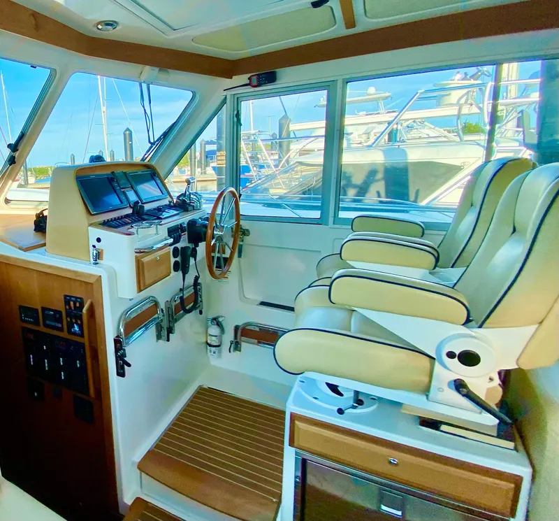 Slide: The Image of Interior of 2014 Back Cove 41 boat with helm, controls, and seating. - 31