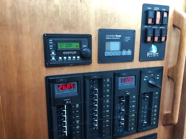 Slide: The Image of Control panel of a 2014 Back Cove 41 yacht with marine generator and circuit breakers. - 39