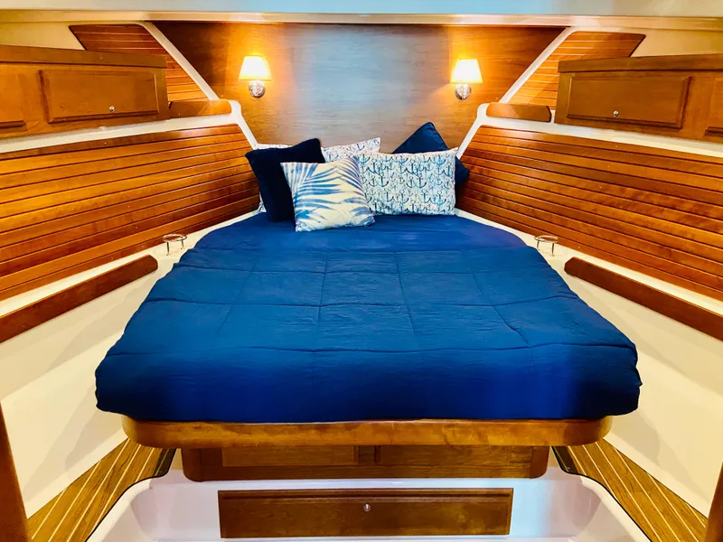 Slide: The Image of Luxurious cabin interior of 2014 Back Cove 41 yacht with cozy bedding and warm lighting. - 41