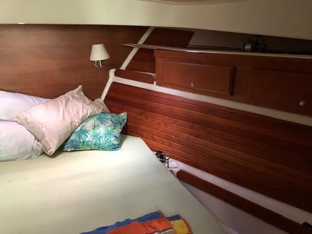 Slide: The Image of Cozy cabin interior of 2014 Back Cove 41 yacht with wooden paneling and bedding. - 45