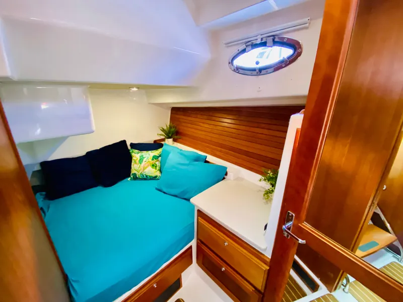 Slide: The Image of Cozy cabin interior of 2014 Back Cove 41 yacht with teal bedding and wooden accents. - 47