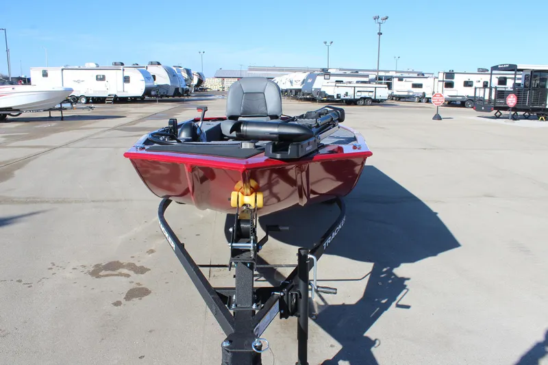 Slide: The Image of 2025 Tracker Panfish 17 boat on trailer, parked in a lot with RVs. - 3