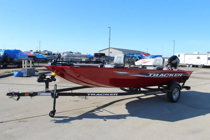 Slide: The Image of 2025 Tracker Panfish 17 boat on trailer, red exterior, parked outdoors. - 4