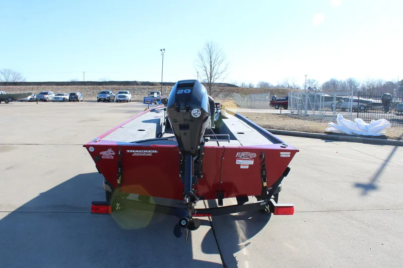 Slide: The Image of 2025 Tracker Panfish 17 boat with outboard motor, parked on concrete lot. - 7