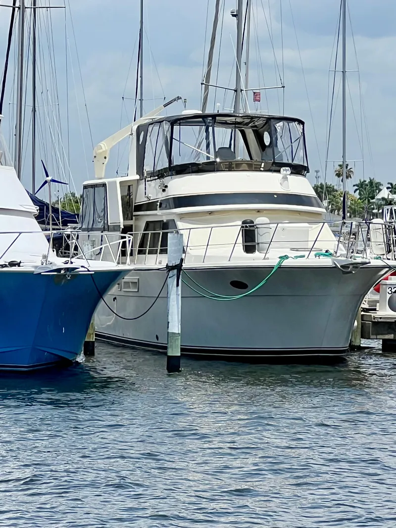 Slide: The Image of 1989 Californian 48MY yacht docked at marina, surrounded by other boats. - 0