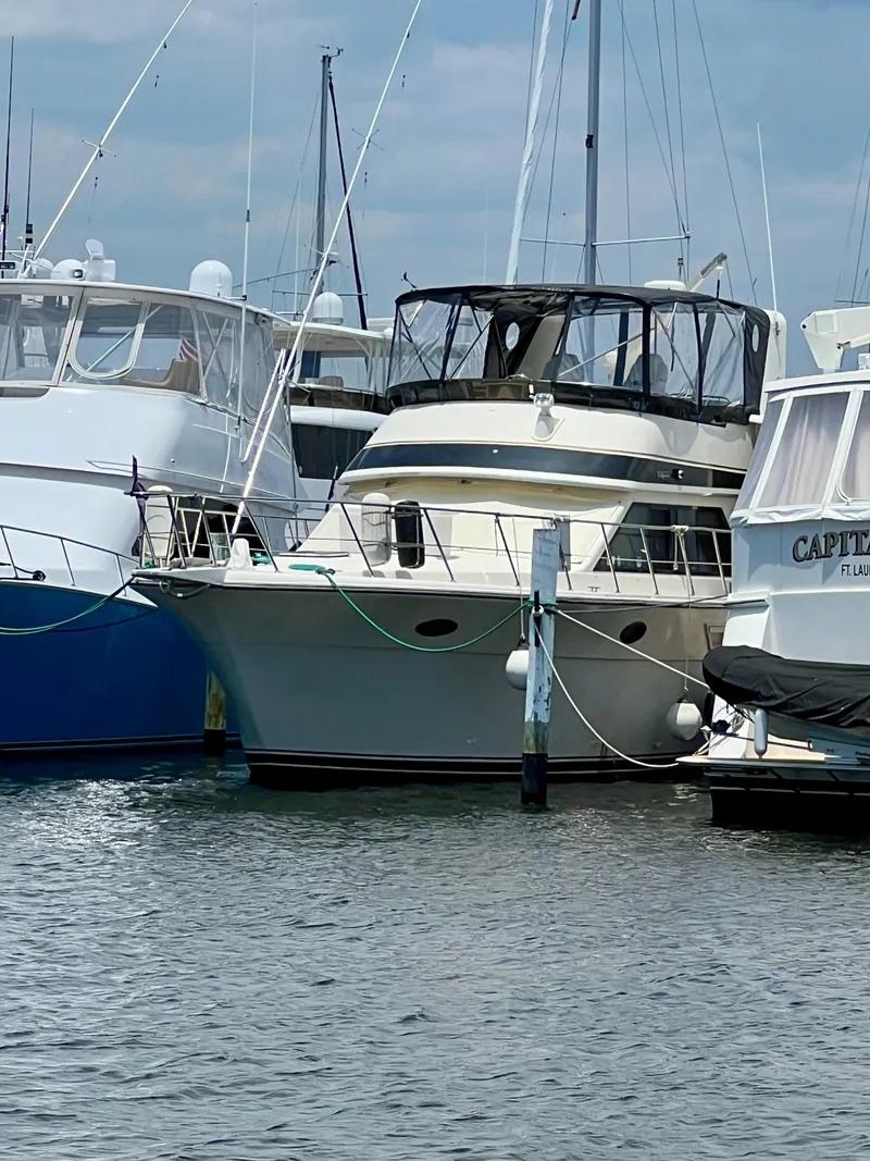 Slide: The Image of 1989 Californian 48MY yacht docked at marina, surrounded by other boats. - 1