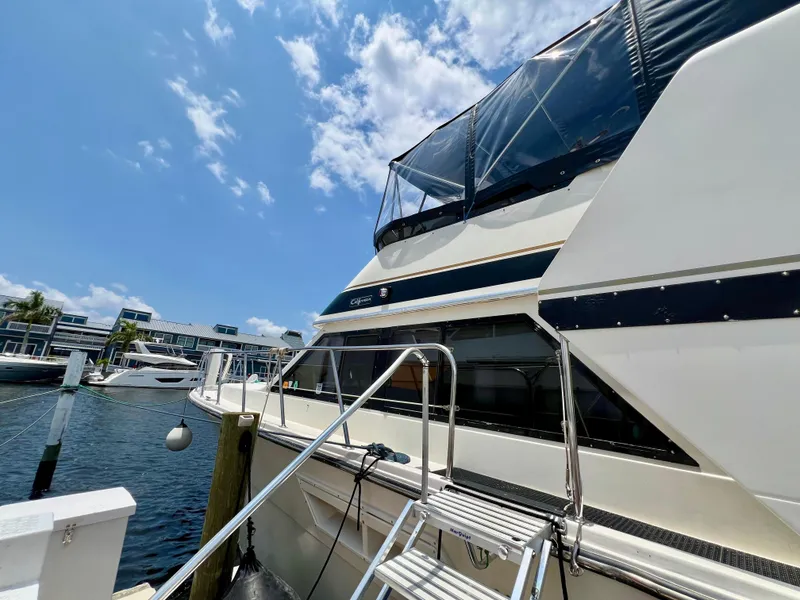 Slide: The Image of 1989 Californian 48MY yacht docked under a clear blue sky. - 10