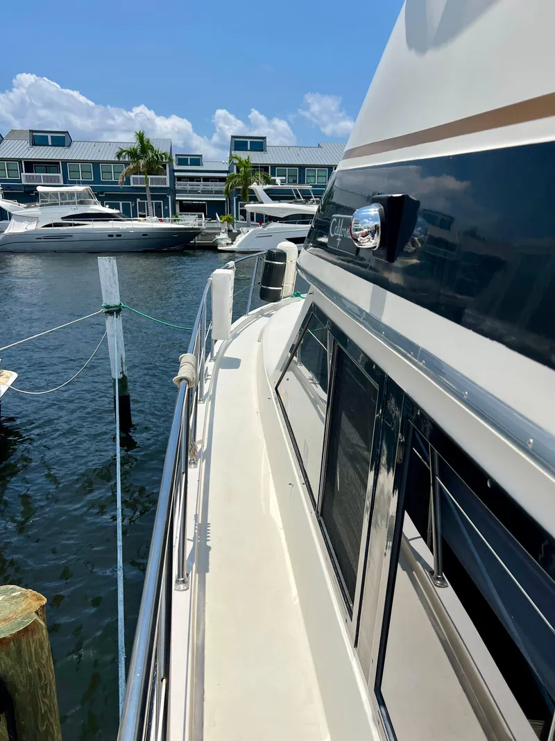 Slide: The Image of 1989 Californian 48MY yacht docked at marina, sunny day, waterfront view. - 11