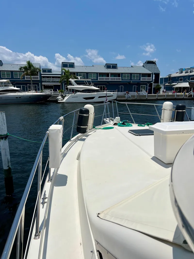 Slide: The Image of 1989 Californian 48MY yacht docked at marina with waterfront buildings in background. - 12
