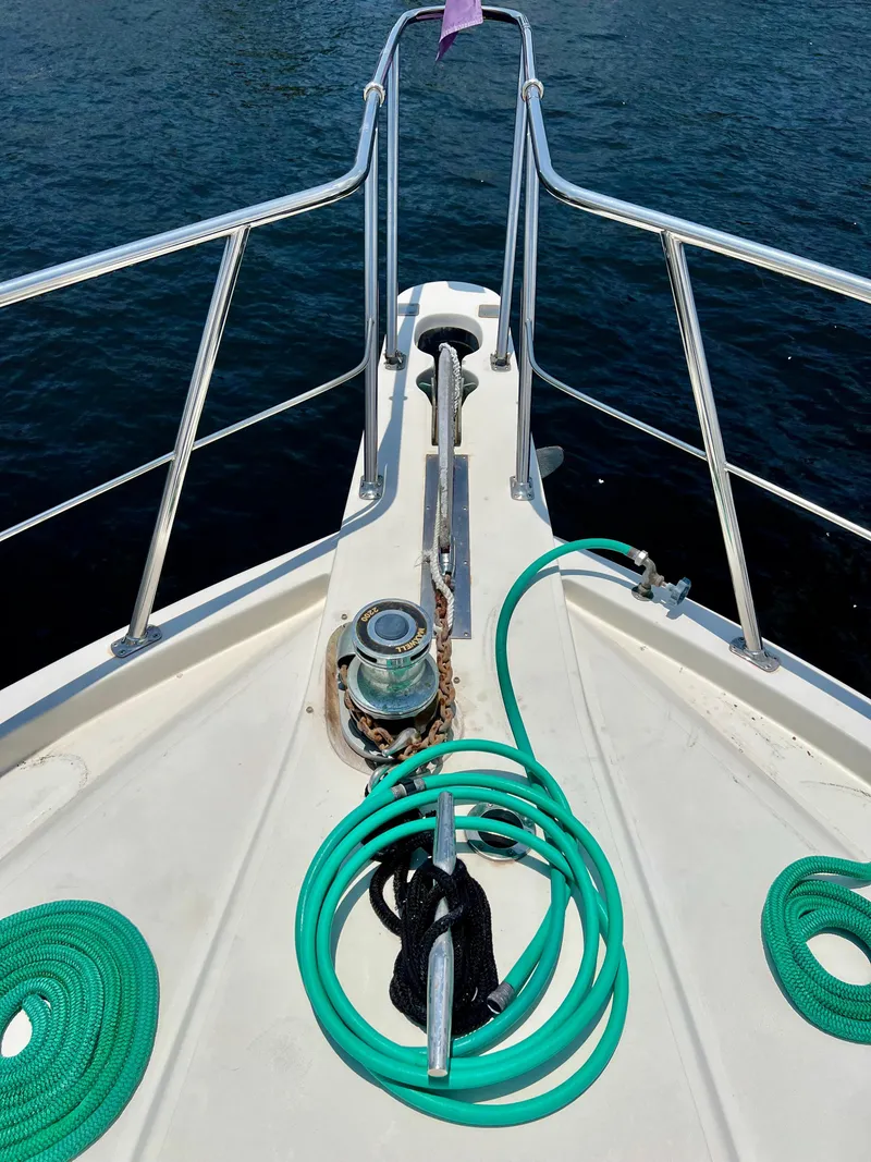 Slide: The Image of Bow of 1989 Californian 48MY yacht with anchor chain and green ropes. - 14