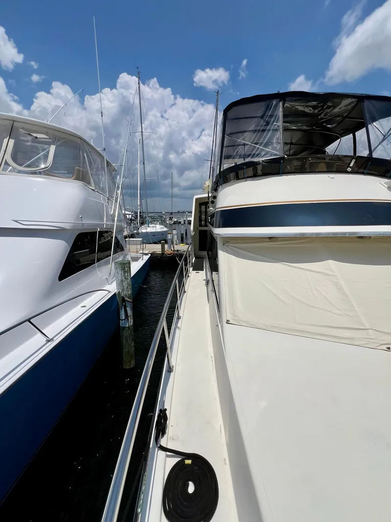Slide: The Image of 1989 Californian 48MY yacht docked at marina under blue sky. - 15
