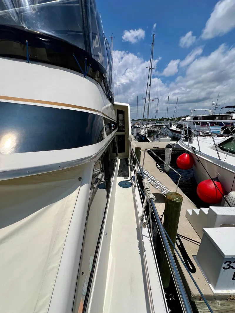 Slide: The Image of 1989 Californian 48MY yacht docked at marina under blue sky. - 17