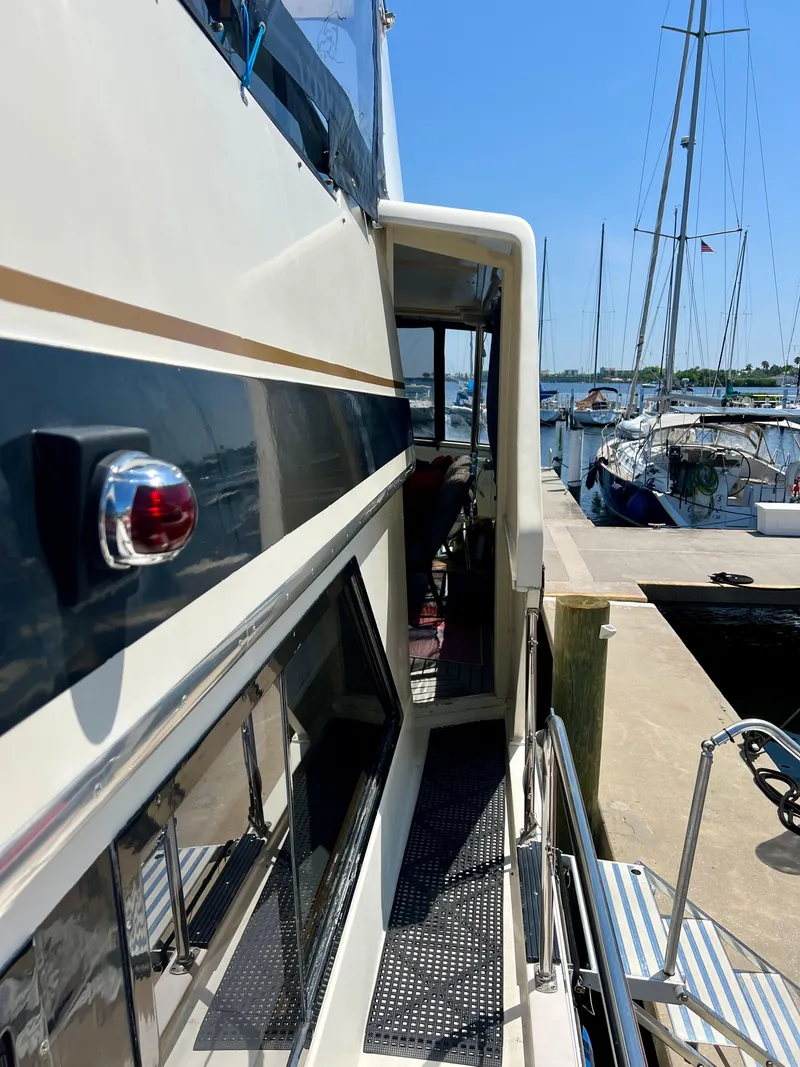 Slide: The Image of 1989 Californian 48MY yacht docked at marina, side view with clear blue sky. - 18