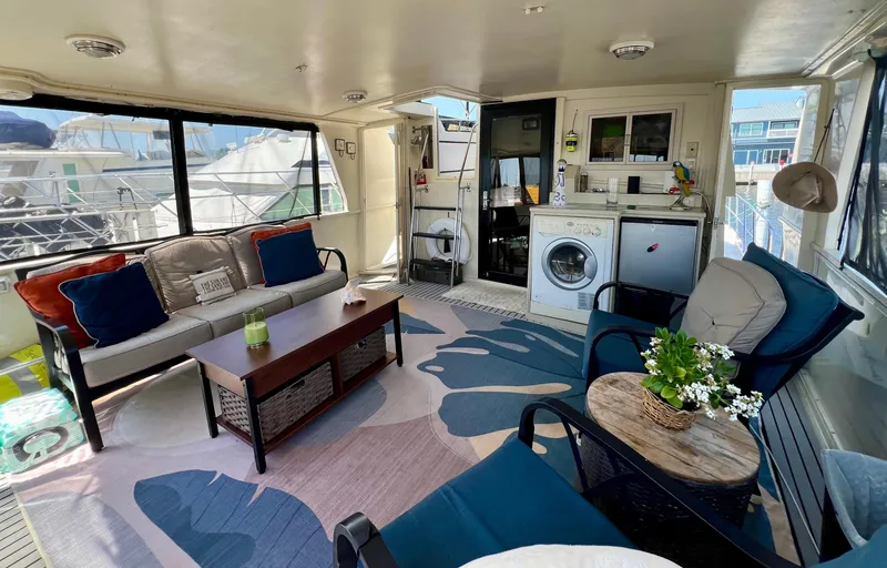 Slide: The Image of Cozy interior of 1989 Californian 48MY yacht with seating, washer, and decor. - 21