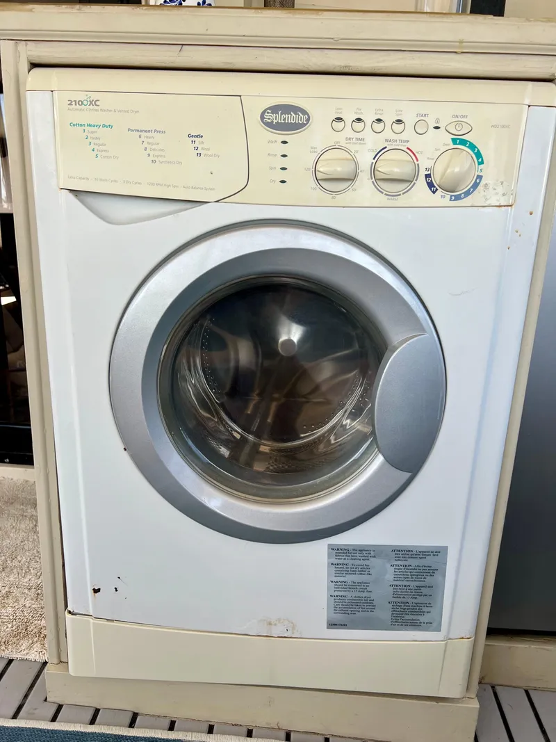 Slide: The Image of Vintage Splendide washing machine, front-loading, with control knobs and settings, model 2100XC. - 24