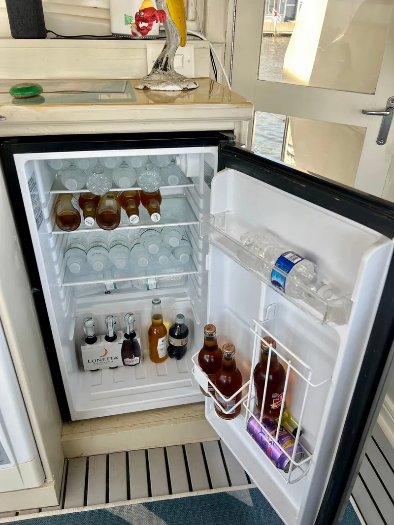 Slide: The Image of Mini fridge stocked with drinks on a 1989 Californian 48MY yacht. - 25