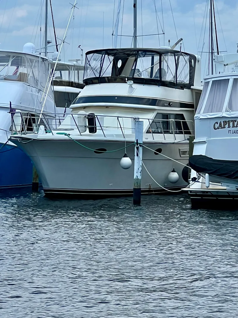 Slide: The Image of 1989 Californian 48MY yacht docked at marina, surrounded by other boats. - 3