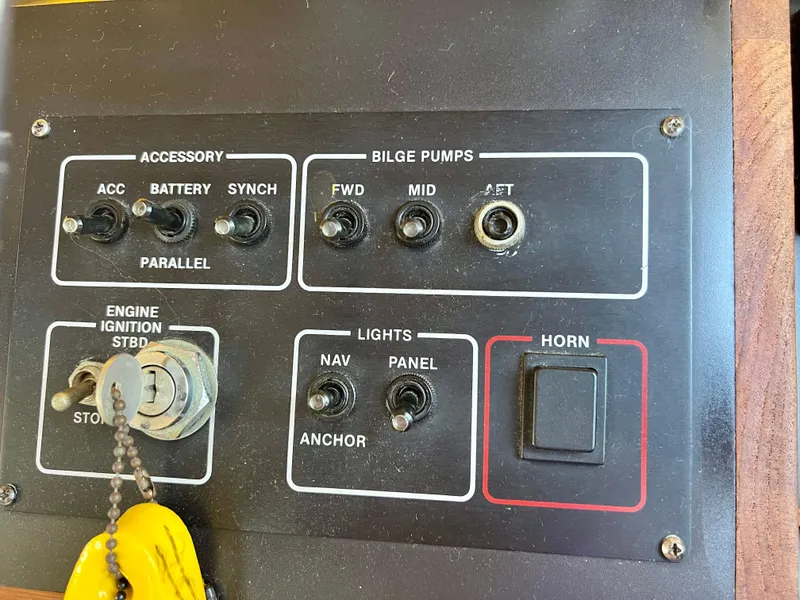 Slide: The Image of Control panel of a 1989 Californian 48MY boat with switches and ignition key. - 35