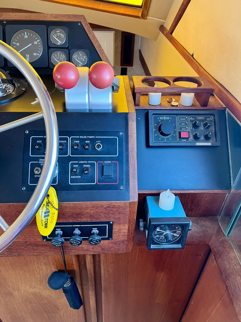 Slide: The Image of 1989 Californian 48MY yacht helm with controls, gauges, and steering wheel. - 36