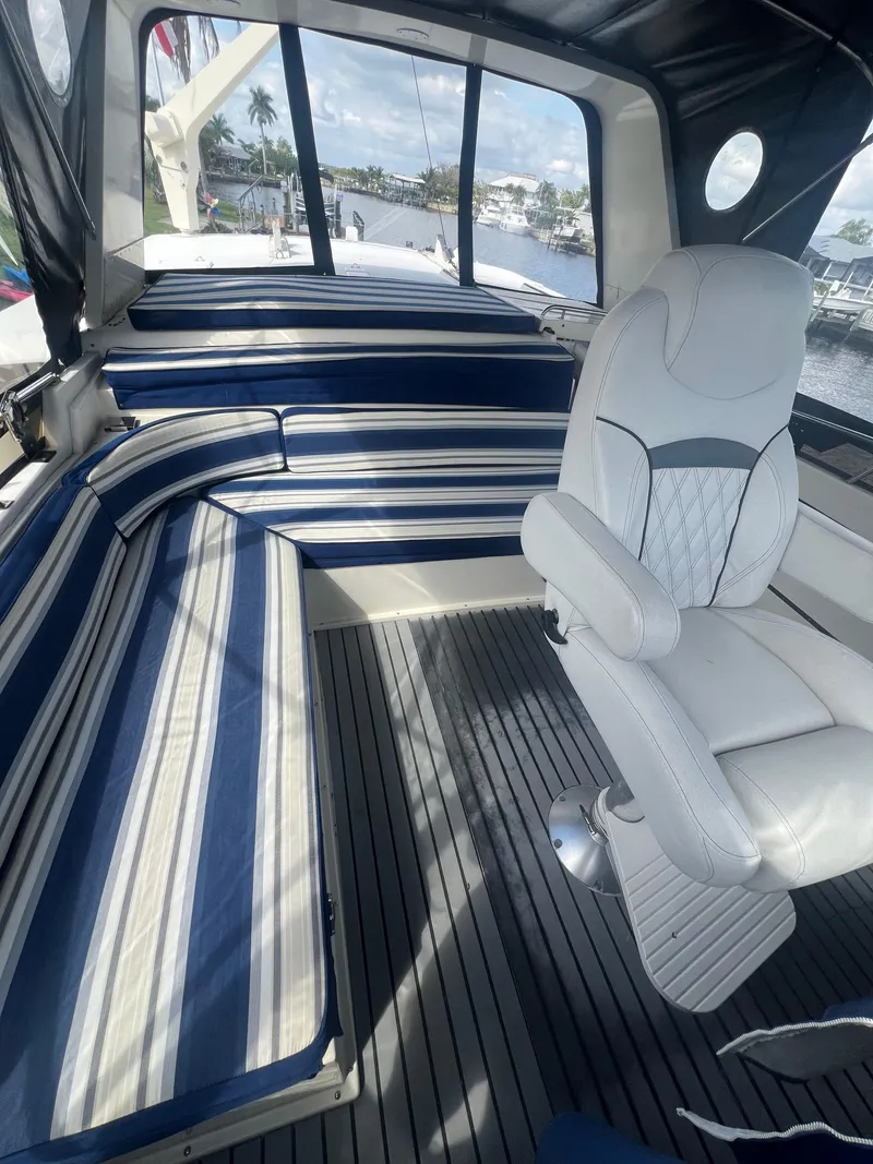 Slide: The Image of Interior of 1989 Californian 48MY yacht with striped seating and white captain's chair. - 4
