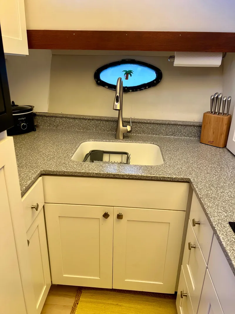 Slide: The Image of Kitchen area in a 1989 Californian 48MY yacht with modern sink and countertop. - 45