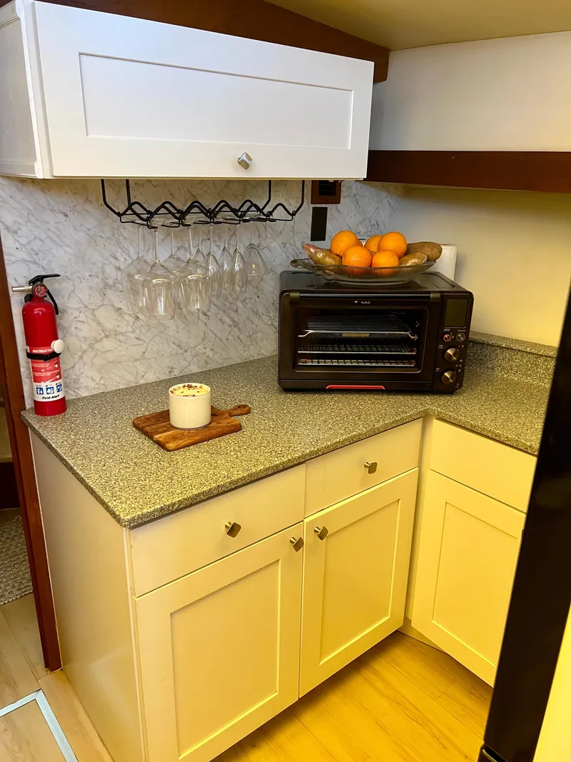 Slide: The Image of Compact kitchen in 1989 Californian 48MY yacht with toaster oven and fruit bowl. - 49