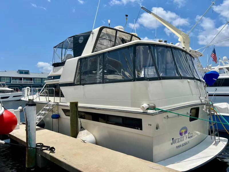 Slide: The Image of 1989 Californian 48MY yacht docked at marina under clear blue sky. - 9