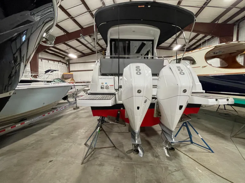 Slide: The Image of 2022 Beneteau Antares 9 with dual outboard engines in a storage facility. - 11