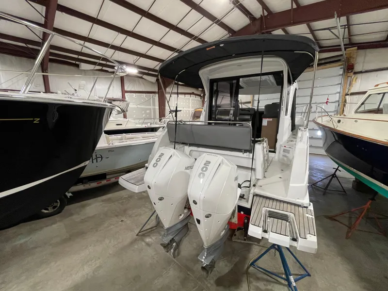 Slide: The Image of 2022 Beneteau Antares 9 boat in storage, featuring dual outboard engines. - 12