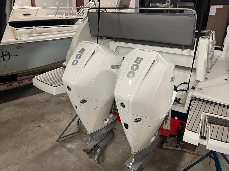 Slide: The Image of 2022 Beneteau Antares 9 with dual Mercury 200 outboard engines in a showroom. - 13