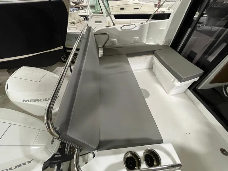 Slide: The Image of 2022 Beneteau Antares 9 boat interior with seating and Mercury engines. - 15