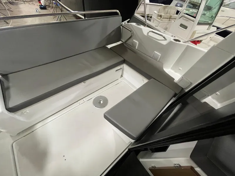 Slide: The Image of 2022 Beneteau Antares 9 interior seating area with gray cushions. - 16