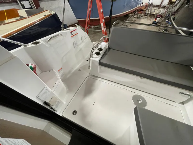 Slide: The Image of 2022 Beneteau Antares 9 boat interior with seating and storage area. - 17