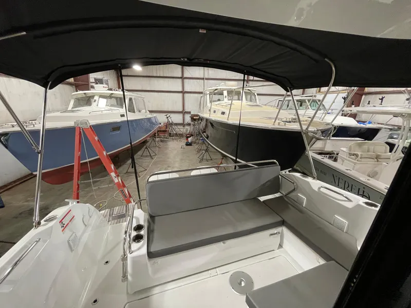 Slide: The Image of 2022 Beneteau Antares 9 in storage, surrounded by other boats. - 18