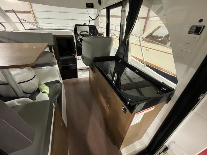 Slide: The Image of Interior of 2022 Beneteau Antares 9 boat, featuring seating and helm station. - 19