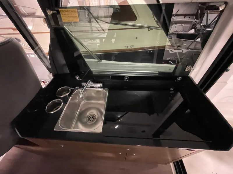 Slide: The Image of 2022 Beneteau Antares 9 interior with sleek kitchenette and stainless steel sink. - 21